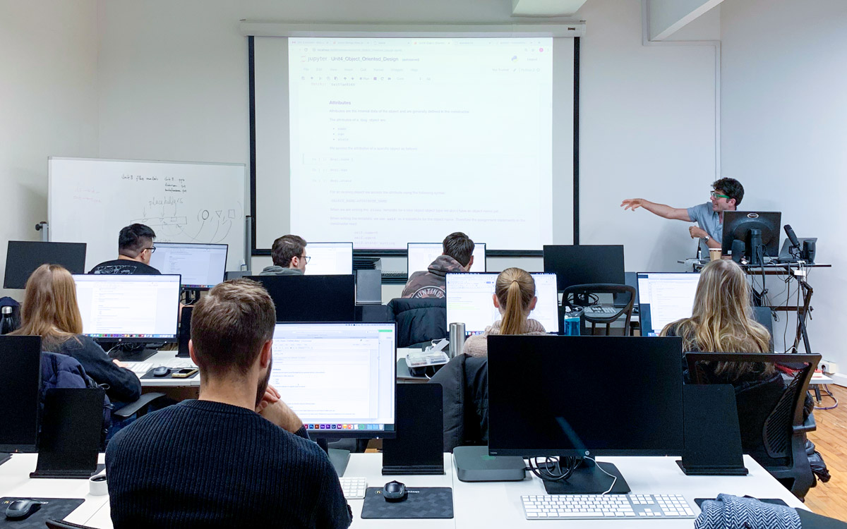 teacher showing something to a student in a classroom